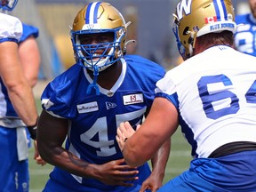 Defensive end Celestin Haba (left) is blocked by Liam Dobson during practice.