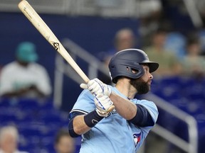 Toronto Blue Jays' Brandon Belt follows through with a single against the Miami Marlins.