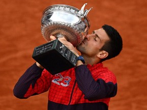 Novak Djokovic of Serbia lifts the winners trophy after victory against Casper Ruud of Norway in the Men's Singles Final match on Day Fifteen of the 2023 French Open at Roland Garros on June 11, 2023 in Paris, France.