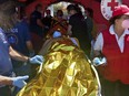 Survivors receive first aid after a rescue operation at the port in Kalamata town, about 240 kilometers (150miles) southwest of Athens on Wednesday, June 14, 2023. Authorities say at least 30 people have died after a fishing boat carrying dozens of migrants capsized and sank off the southern coast of Greece. A large search and rescue operation is underway. Authorities said 104 people have been rescued so far following the incident early Wednesday some 75 kilometers (46 miles) southwest of Greece’s southern Peloponnese region.(www.argolikeseidhseis.gr via AP)