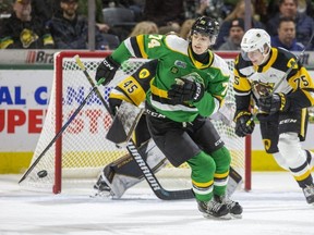 London Knights forward Jacob Julien corrals the puck in front of Hamilton Bulldogs goalie Matter Drobac and defenseman Jorian Donovan during the first period of their OHL game at Budweiser Gardens in London on Friday January 6, 2023. Derek Ruttan/The London Free Press/Postmedia Network