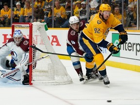 Ryan Johansen, right, of the Nashville Predators and Bowen Byram of the Colorado Avalanche compete for the puck during the first period of Game 4 of the First Round of the 2022 Stanley Cup Playoffs at Bridgestone Arena on May 9, 2022 in Nashville, Tenn.