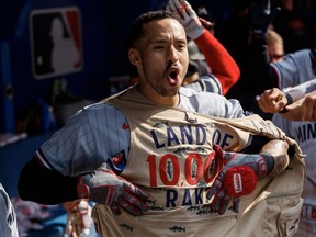 Carlos Correa of the Minnesota Twins wears the team's Land of 10,000 Rakes fishing vest to celebrate his grand slam during the eighth inning of their MLB game against the Toronto Blue Jays at Rogers Centre on June 10, 2023 in Toronto.