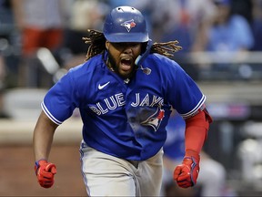 Vladimir Guerrero Jr. of the Toronto Blue Jays reacts after hitting an RBI double during the ninth inning against the New York Mets at Citi Field on Saturday.