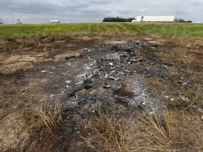 Charred grass where a shuttle bus loaded with twenty five people burned after colliding with a semi at the intersection of highways #1 and #5, near the town of Carberry on Friday June 16, 2023