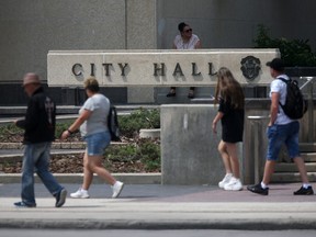 People walking past City Hall in Winnipeg on Wednesday, June 28, 2023.