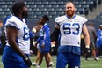 Bombers offensive linemen Stanley Bryant (left) and Pat Neufeld, talk some strategy during practice on Tuesday.