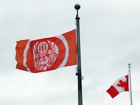 The Survivors' Flag hangs to honour Indigenous Peoples who were forced to attend residential schools, on the grounds of the legislature in Victoria, B.C., on Wednesday, Sept. 28, 2022.