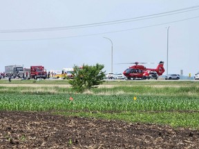 Emergency vehicles line the road at a crash scene near Carberry, west of Winnipeg, on Thursday, June 15, 2023. (Photo by Nirmesh VADERA / AFP)