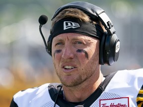 Hamilton Tiger-Cats quarterback Bo Levi Mitchell (19) looks on from the sidelines against the Toronto Argonauts during first half CFL pre-season football action in Hamilton on Saturday, May 27, 2023. Mitchell tops the changing quarterback landscape in the CFL this season.The veteran quarterback enters his ninth season as a league starter but first with Hamilton.THE CANADIAN PRESS/Peter Power