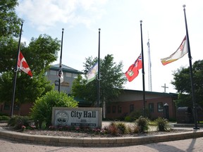 Flags outside Dauphin city hall fly at half mast on Friday June 16, 2023.&ampnbsp;A western Manitoba community is grappling with how to honour the lives lost in a fiery bus crash that killed 15 seniors last week.