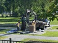 Workers reinstall a statue of Queen Elizabeth that was toppled on Canada Day 2021 on the grounds of the Manitoba legislature in Winnipeg on Friday June 2, 2023.