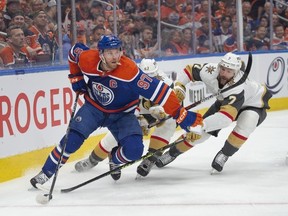 Connor McDavid (97) of the Edmonton Oilers, fends off Alec Martinez and Alex Pietrangelo of the Las Vegas Golden Knights in game six of the second round of the NHL playoffs at Rogers Place in Edmonton on May 14, 2023.