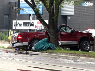 A truck involved in a crash with a police cruiser sits up against a tree on a Main Street boulevard between Kilbride and Belmont avenues in Winnipeg on Wed., June 7, 2023.  KEVIN KING/Winnipeg Sun