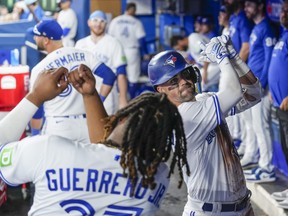 Whit Merrifield re-enacts his home run swing with Vladimir Guerrero Jr., following his fourth-inning go-ahead blast against the Arizona Diamondbacks in the fourth inning at the Rogers Centre on July 15, 2023.