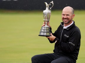 Brian Harman of the United States poses for a photograph with the Claret Jug after winning The 151st Open on the 18th green on Day Four of The 151st Open at Royal Liverpool Golf Club on July 23, 2023 in Hoylake, England.