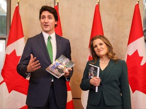 Prime Minister Justin Trudeau and Finance Minister Chrystia Freeland speak to the media, holding the 2023-24 budget, on Parliament Hill in Ottawa, March 28, 2023.