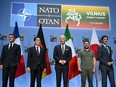 (L to R) French President Emmanuel Macron, Japan's Prime Minister Fumio Kishida, U.S. President Joe Biden, Ukrainian President Volodymyr Zelenskyy and Prime Minister Justin Trudeau pose during an event with G7 leaders to announce a Joint Declaration of Support for Ukraine during the NATO Summit in Vilnius on July 12, 2023.