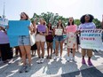 Proponents of affirmative action hold signs during a protest at Harvard University in Cambridge, Mass., on July 1, 2023.