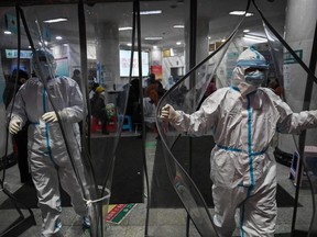 This file photo taken Jan. 25, 2020 shows medical staff members, wearing protective clothing at the Wuhan Red Cross Hospital in Wuhan, as the city struggled with the outbreak of the virus.