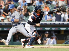 Daulton Varsho of the Toronto Blue Jays scores past catcher Eric Haase of the Detroit Tigers on a double by Nathan Lukes during the 10th inning at Comerica Park on July 9, 2023 in Detroit.