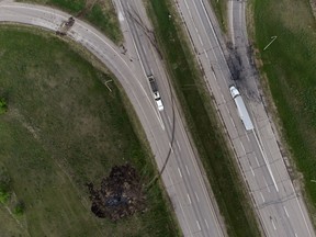 A scorched patch of ground where a bus carrying seniors ended up after colliding with a semi-trailer truck and burning is seen on the edge of the Trans-Canada Highway near Carberry, Man., on Friday, June 16, 2023.
