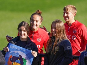 Canada's Julia Grosso, left, and Quinn pose for a photo with supporters during a training session ahead of the FIFA Women's World Cup in Melbourne, Australia, Monday, July 17, 2023.