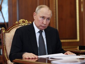 Vladimir Putin at a desk