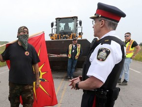 A policeman and a protester at the Brady Road blockade