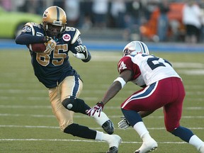 Winnipeg Blue Bombers SB Milt Stegall tries to beat Montreal Alouettes DB Drew Randee during CFL action at Canad Inns Stadium.
