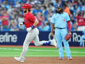 Philadelphia Phillies' Bryce Harper rounds the bases after hitting a solo home run as Toronto Blue Jays first baseman Vladimir Guerrero Jr. looks on during the third inning on Wednesday, Aug. 16, 2023 at the Rogers Centre.