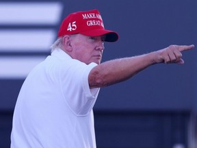 Former U.S. President Donald Trump waves to the crowd on the 16th tee during the LIV Golf Invitational - Bedminster at Trump National Golf Club in Bedminster, N.J., Saturday, Aug. 13, 2023.