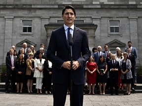 Members of the federal cabinet stand behind Prime Minister Justin Trudeau as he speaks at a media availability after a cabinet shuffle, at Rideau Hall in Ottawa, on Wednesday, July 26, 2023.