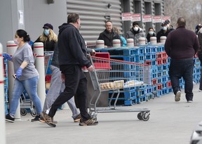 Costco customers line up for products in East York on March 26, 2020.