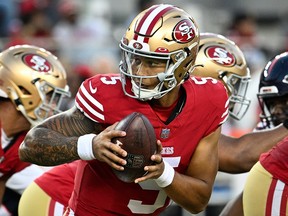Trey Lance of the San Francisco 49ers hands the ball off during a preseason game against the Denver Broncos at Levi's Stadium on August 19, 2023 in Santa Clara, California.