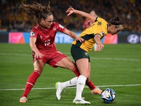 Australia's forward #09 Caitlin Foord (R) fights for the ball with Denmark's midfielder #19 Janni Thomsen (L) during the Australia and New Zealand 2023 Women's World Cup round of 16 football match between Australia and Denmark at Stadium Australia in Sydney on August 7, 2023.
