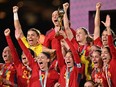 Spain's defender #05 Ivana Andres lifts the trophy on the podium in celebration after winning the Australia and New Zealand 2023 Women's World Cup final football match between Spain and England at Stadium Australia in Sydney on August 20, 2023.