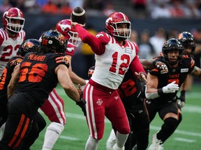 Calgary Stampeders quarterback Jake Maier passes while under pressure from the B.C. Lions defence at BC Place in Vancouver, on Saturday, Aug. 12, 2023.