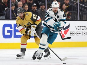 Erik Karlsson of the San Jose Sharks skates with the puck against Keegan Kolesar of the Vegas Golden Knights at T-Mobile Arena on February 16, 2023 in Las Vegas.