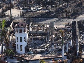 In an aerial view, part of a structure still stands after being destroyed by a wildfire on Aug. 11, 2023 in Lahaina, Hawaii.