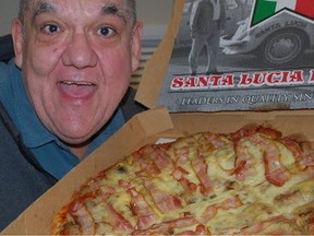 Hal Anderson poses with his pizza from Santa Lucia.
