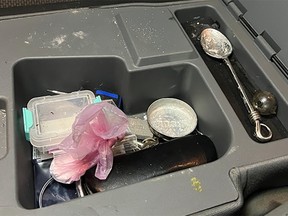 Items found in the centre armrest of a suspicious vehicle