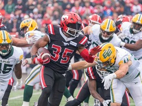 Calgary Stampeders running back Ka’Deem Carey rushes against the Edmonton Elks during the Labour Day Classic at McMahon Stadium on Monday, Sept. 4, 2023.