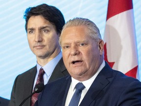 Ontario Premier Doug Ford answers questions as Prime Minister Justin Trudeau listens at CAMI in Ingersoll, Ont. on Monday December 5, 2022.