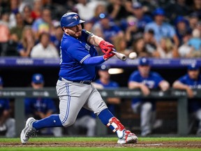Alejandro Kirk of the Toronto Blue Jays hits a three-RBI double in the seventh inning against the Colorado Rockies at Coors Field on Sept. 1, 2023 in Denver.