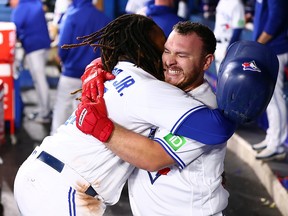 Alejandro Kirk of the Blue Jays celebrates with Vladimir Guerrero Jr. after hitting a home run against the Tampa Bay Rays at Rogers Centre on September 29, 2023 in Toronto.