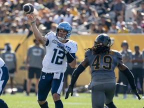 Toronto Argonauts quarterback Chad Kelly (12) throws during CFL action against the Hamilton Tiger-Cats in the annual Labour Day Classic in Hamilton, Ont. on Monday,