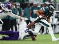 Danielle Hunter (99) of the Minnesota Vikings sacks Jalen Hurts (1) of the Philadelphia Eagles during the fourth quarter at Lincoln Financial Field on Sept. 14, 2023 in Philadelphia, Pa.