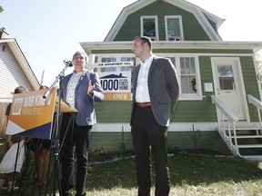 Manitoba New Democrats are promising financial help for families who want to make the switch to a geothermal heating and cooling system if elected on Oct. 3. Wab Kinew, leader of the Manitoba NDP, left, speaks during a press conference in Winnipeg Friday, Aug. 16, 2019, as Adrien Sala, NDP candidate for St James, listens in.
