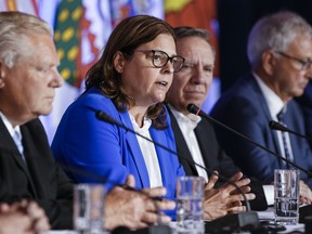 Despite her 23 years as a politician -- and almost two as Manitoba's first female premier -- Heather Stefanson says she is still getting used to the public spotlight. Stefanson, centre, Chair of the Council of the Federation, speaks to media as Ontario Premier Doug Ford and Quebec Premier Francois Legault listen in during the closing news conference at the Council of the Federation, in Winnipeg, Wednesday, July 12, 2023.